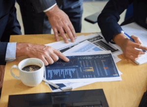 Investors looking at a graph on a sheet of paper